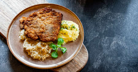 Pork breaded cutlet coated with breadcrumbs with mashed potatoes and cabbageの写真素材