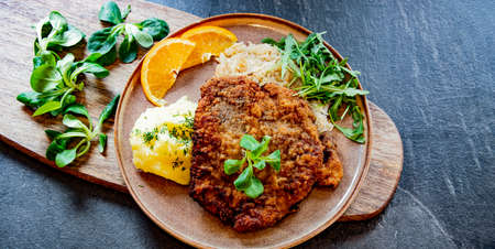 Pork breaded cutlet coated with breadcrumbs with mashed potatoes and cabbageの写真素材