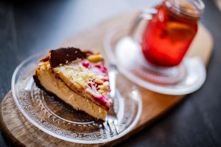 Cheesecake and a glass with hot fruit drinkの写真素材