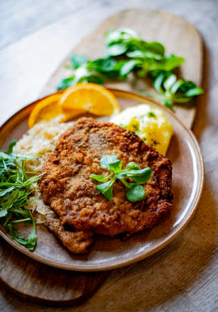 Pork breaded cutlet coated with breadcrumbs with mashed potatoes and cabbageの写真素材