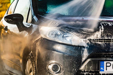 A vehicle in a coin-operated self-service car washの写真素材