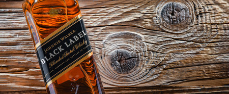 POZNAN, POL - APR 13, 2022: Bottle of Johnnie Walker, the most widely distributed brand of blended Scotch whiskey in the world with sales of over 130 million bottles a year.のeditorial素材