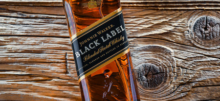 POZNAN, POL - APR 13, 2022: Bottle of Johnnie Walker, the most widely distributed brand of blended Scotch whiskey in the world with sales of over 130 million bottles a year.のeditorial素材