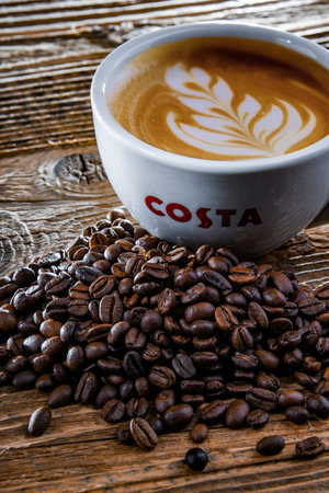 POZNAN, POL - APR 14, 2022: Cup of Costa coffee, a brand of British multinational coffeehouse company headquartered in Dunstable, Bedfordshire; second largest coffeehouse chain in the worldのeditorial素材