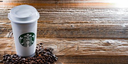 POZNAN, POL - APR 14, 2022: Cup of Starbucks, the name of coffee company and coffeehouse chain, founded in Seattle, Wa. USA, in 1971; now the largest business of this kind in the world.のeditorial素材