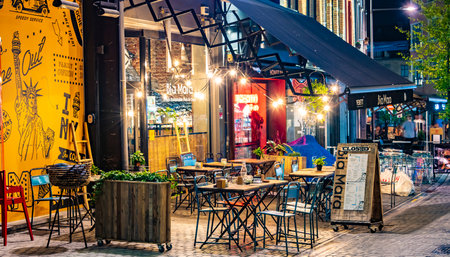 LEUVEN, BELGIUM - AUG 25, 2022: Restaurants in the old town of Leuven, in the Flemish Region of Belgium, in the night