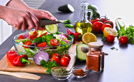 Preparation of a vegetable salad from fresh organic ingredients.の写真素材