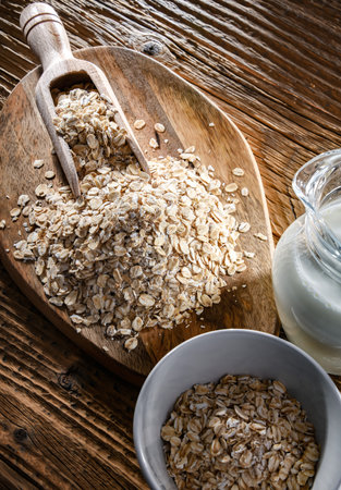 Rolled oats on the wooden cutting board.