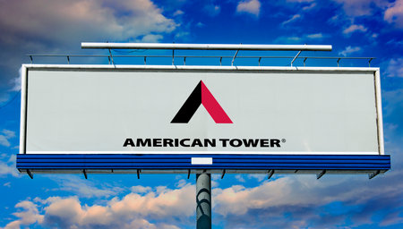 POZNAN, POL - MAY 1, 2022: Advertisement billboard displaying logo of American Tower Corporation, a real estate investment trust and an owner and operator of wireless and broadcast communications infrastructureのeditorial素材