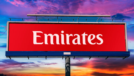 POZNAN, POL - MAY 1, 2022: Advertisement billboard displaying logo of Emirates, a state-owned airline based in Garhoud, Dubai, United Arab Emiratesのeditorial素材