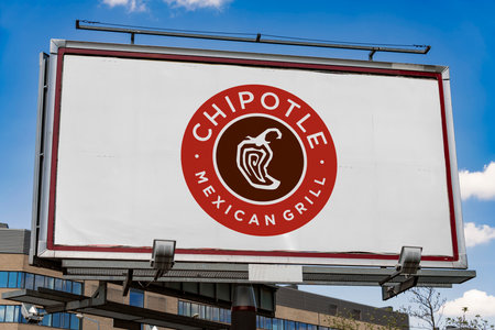 POZNAN, POL - MAY 1, 2022: Advertisement billboard displaying logo of Chipotle Mexican Grill, an American chain of fast casual restaurantsのeditorial素材