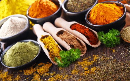Variety of spices on wooden kitchen table.の写真素材