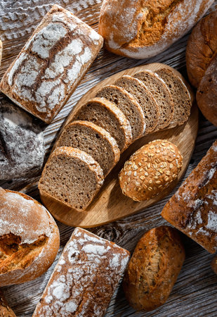 Assorted bakery products including loaves of bread and rollsの写真素材