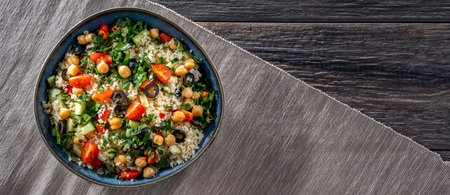 A plate of couscous served with vegetables and chickpeasの写真素材