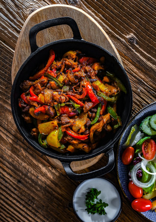 Fajita with stripped peppers and onions served on a hot iron skilletの写真素材
