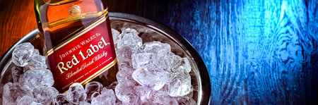 POZNAN, POL - FEB 28, 2024: Bottle of Johnnie Walker, the most widely distributed brand of blended Scotch whiskey in the world with sales of over 130 million bottles a year.のeditorial素材