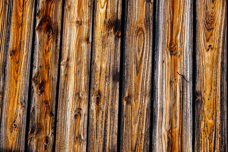 Boards on the wall of an old abandoned wooden houseの写真素材