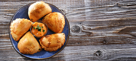 Composition with a plate of oven-baked dumplings