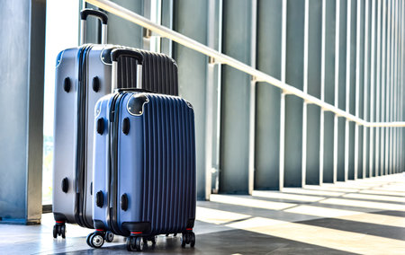 Two plastic travel suitcases in the hall.の写真素材