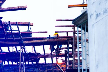Construction team working at height site. Construction workers fabricating steel reinforcement bar at the construction site.welding steel.の写真素材