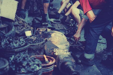 Repairman old Machine parts in warehouses. Car parts in old warehouses. Used vehicle part for recycling in the scrap yard garage. Recycle goodsの写真素材
