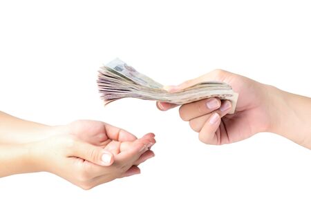 Closeup hands giving money isolated on white backgroundの写真素材
