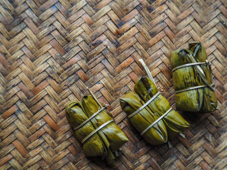 Boiled rice wrapped in banana leaves  Put on bamboo tの写真素材