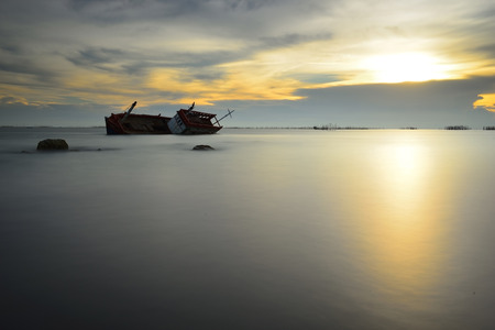 A boat capsized in the Seaの写真素材