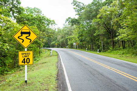 Yellow slippery road with speed limit sign on high way.の写真素材