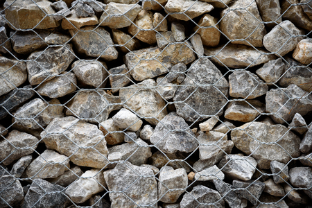 Stone with wire mesh for protection rock falling from mountainの写真素材
