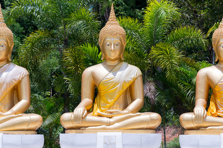 Golden Buddha statue in public temple Thailandの写真素材