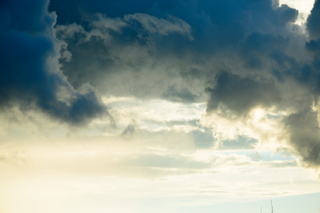 Background of golden storm clouds at sunset.の写真素材
