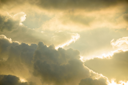 Background of golden storm clouds at sunset.の写真素材
