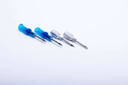 4 syringes lined up on a white backgroundの写真素材