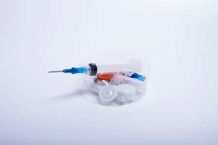The active syringe is collected in a white clear plastic box. on the white backgroundの写真素材