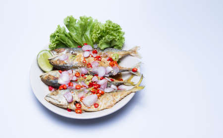 Thai food. Salted mackerel. Salted. Decorate and eat. Place on a white plate on a white background.の写真素材