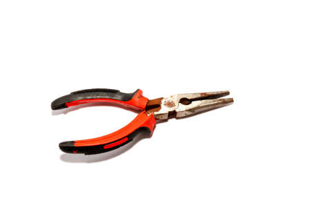 Old rusted pliers, rubber grip, 2 colors, black-red, old equipment placed on a white background, viewed from aboveの写真素材