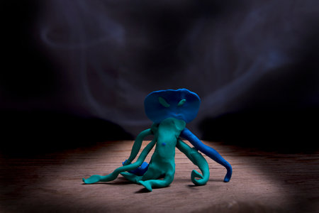 Plasticine Monster Receive Halloween Placed on a wooden floor with a backdrop of black floating smoke.の写真素材