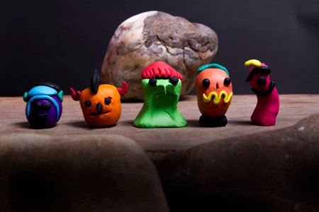 5 plasticine monsters, made on Halloween, placed on wooden floors and rocks.の写真素材