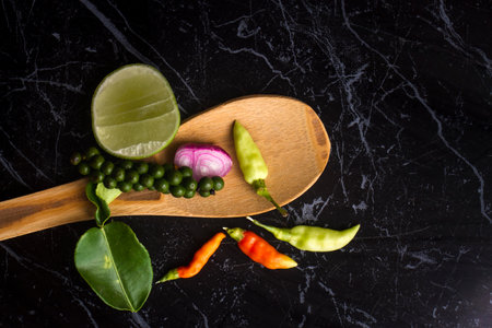 Herbs and spices In the form of Thai food On a black stone slabの写真素材