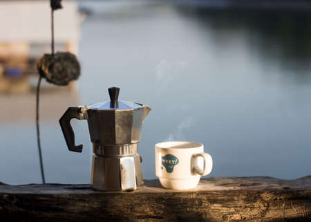 Morning hot coffee with traditional coffee pots The background image is a sea view.の写真素材