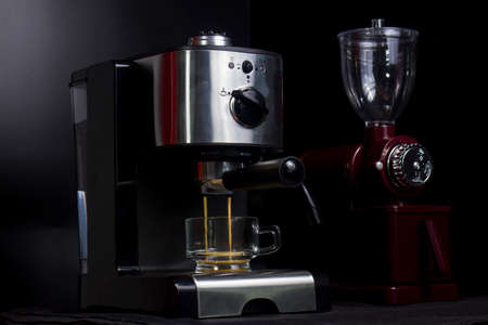 Hot espresso flows into the cup. Making espresso in a clear glass coffee cupの写真素材