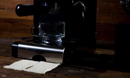 Make an espresso in a clear glass coffee cup. The background is classic old wood.の写真素材