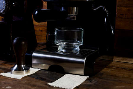 Make an espresso in a clear glass coffee cup. The background is classic old wood.の写真素材