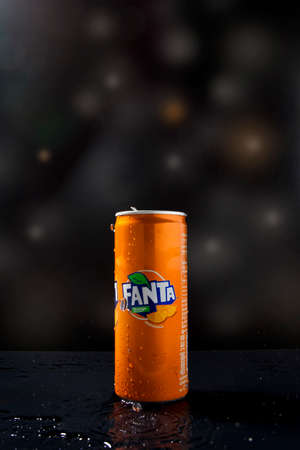 Surat Thani - Thailand - September 2020 Fanta is cool and has condensation on the side of the canister. English inscription on black background with light and bokehのeditorial素材
