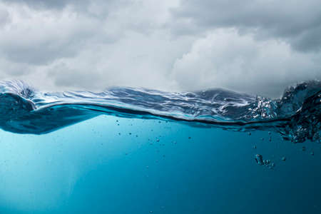 The deep blue sea at the time of the storm can be seen from under the water. Abstract wave blur under waterの写真素材