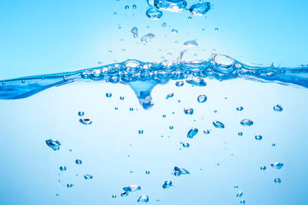 Water waves Splashed water wave in clean blue waterの写真素材