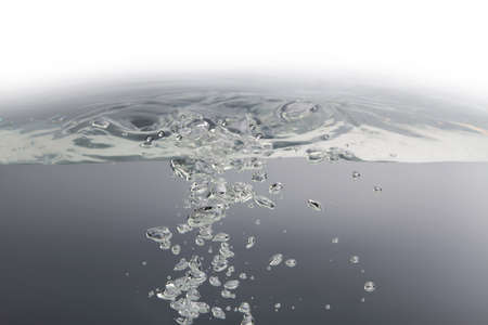 Many of the bubbles floating in the water are caused by waves on the surface. gray backgroundの写真素材