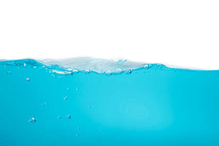 The crashing waves created air bubbles and scattered water. small bubbles float from the middle of the water to the surface blue liquid backgroundの写真素材