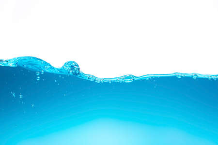 Bright blue water waves create small bubbles. water waves splashing in clear blue waterの写真素材
